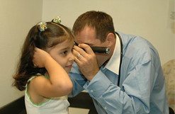 Dr. Watson examining a patient's ear.
